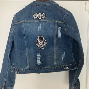 NWT.  Distressed washed jean jacket.  Skull themed.   Size S